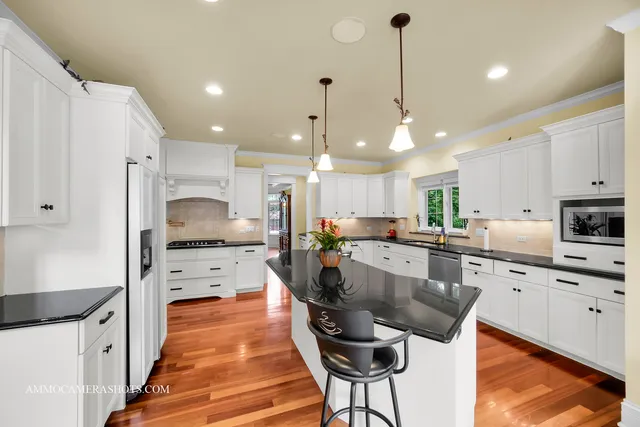 a large kitchen with lots of counter space a sink and appliances