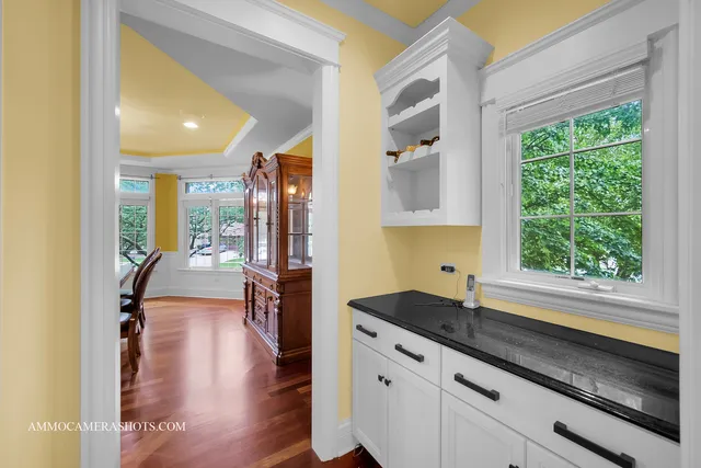 an empty room with a window and a ceiling fan