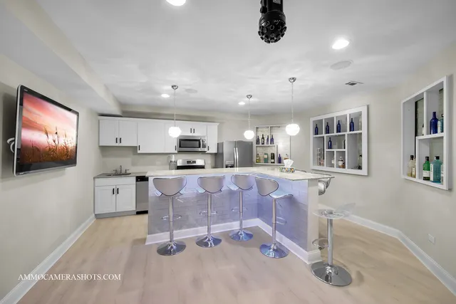 an aerial view of residential houses with outdoor space and trees