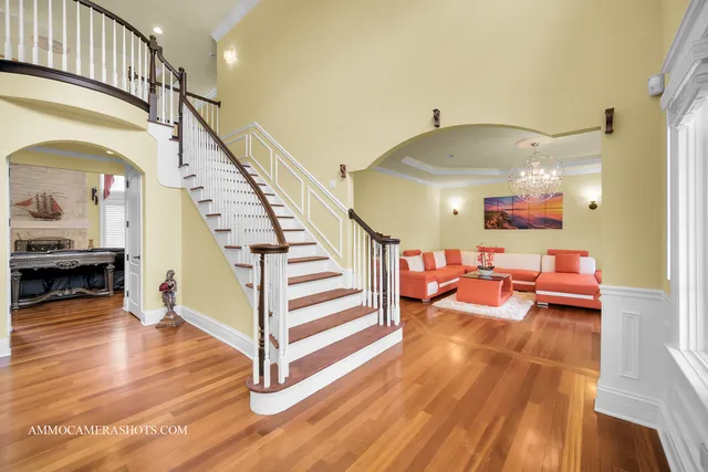 a living room with furniture and a chandelier