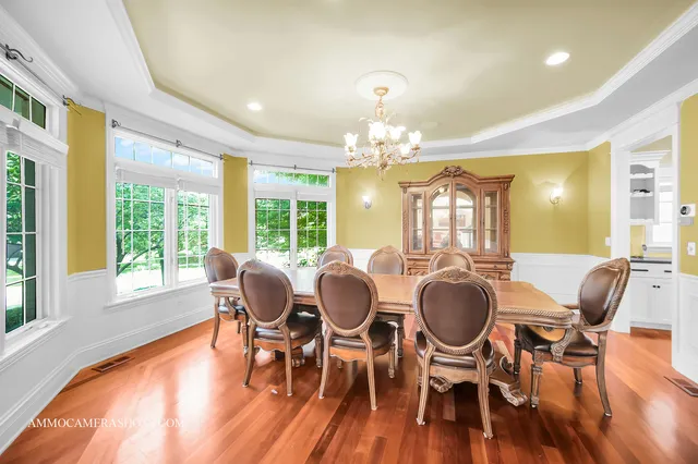 a view of a dining room with furniture wooden floor and chandelier