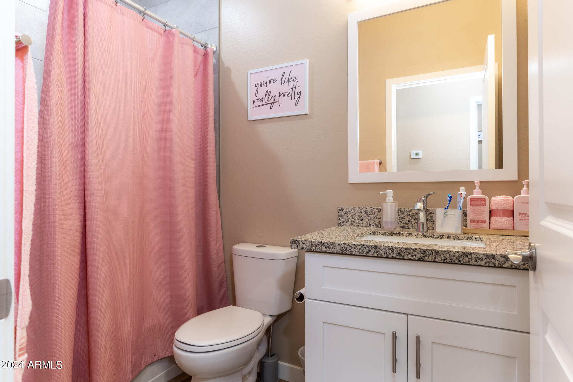 14594 South Avalon Road Arizona City, AZ 85123 - Photo 12 of 21 a bathroom with a granite countertop sink mirror vanity and toilet