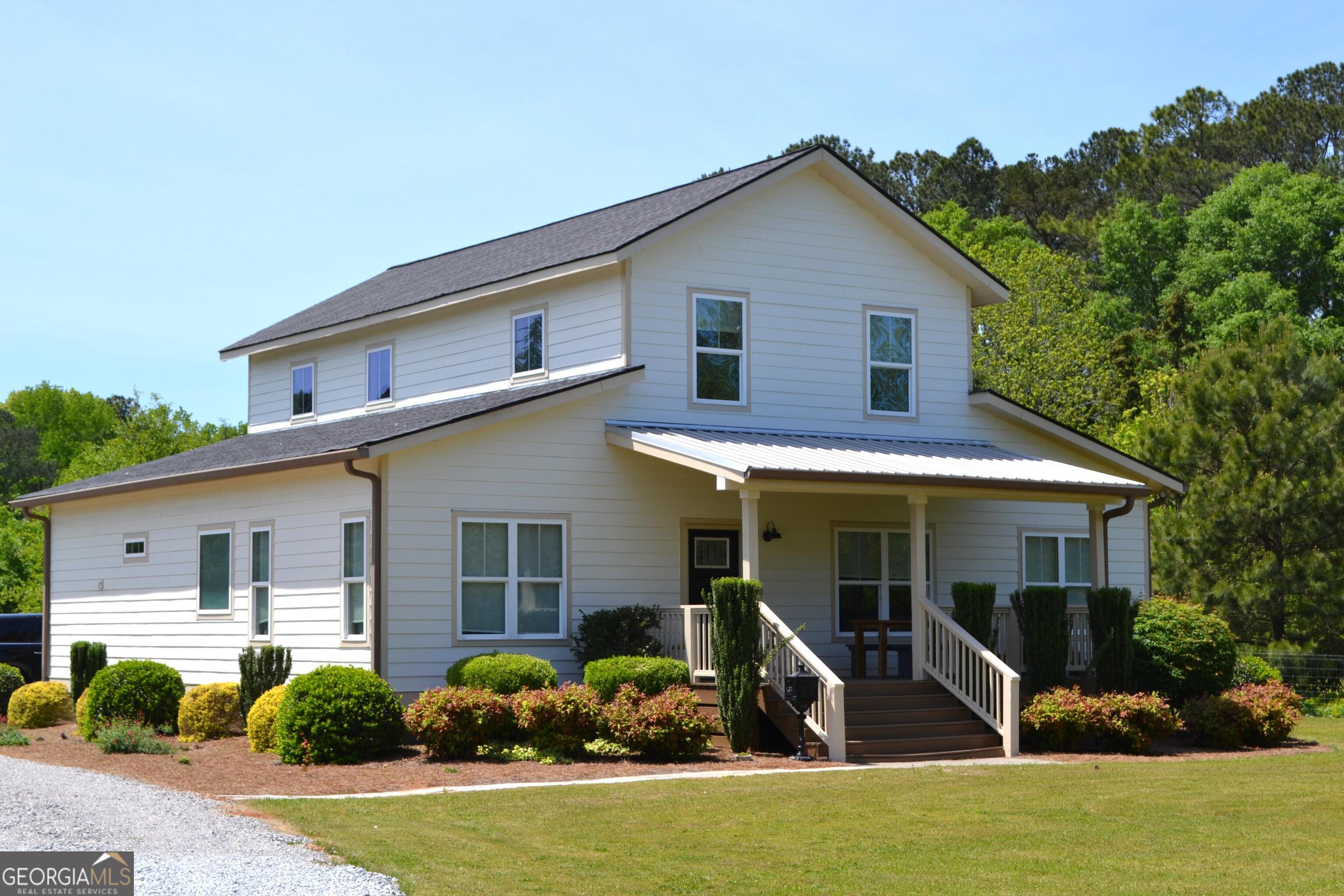 3650 Colham Ferry Road Watkinsville, GA 30677 - Photo 1 of 1 a front view of a house with garden