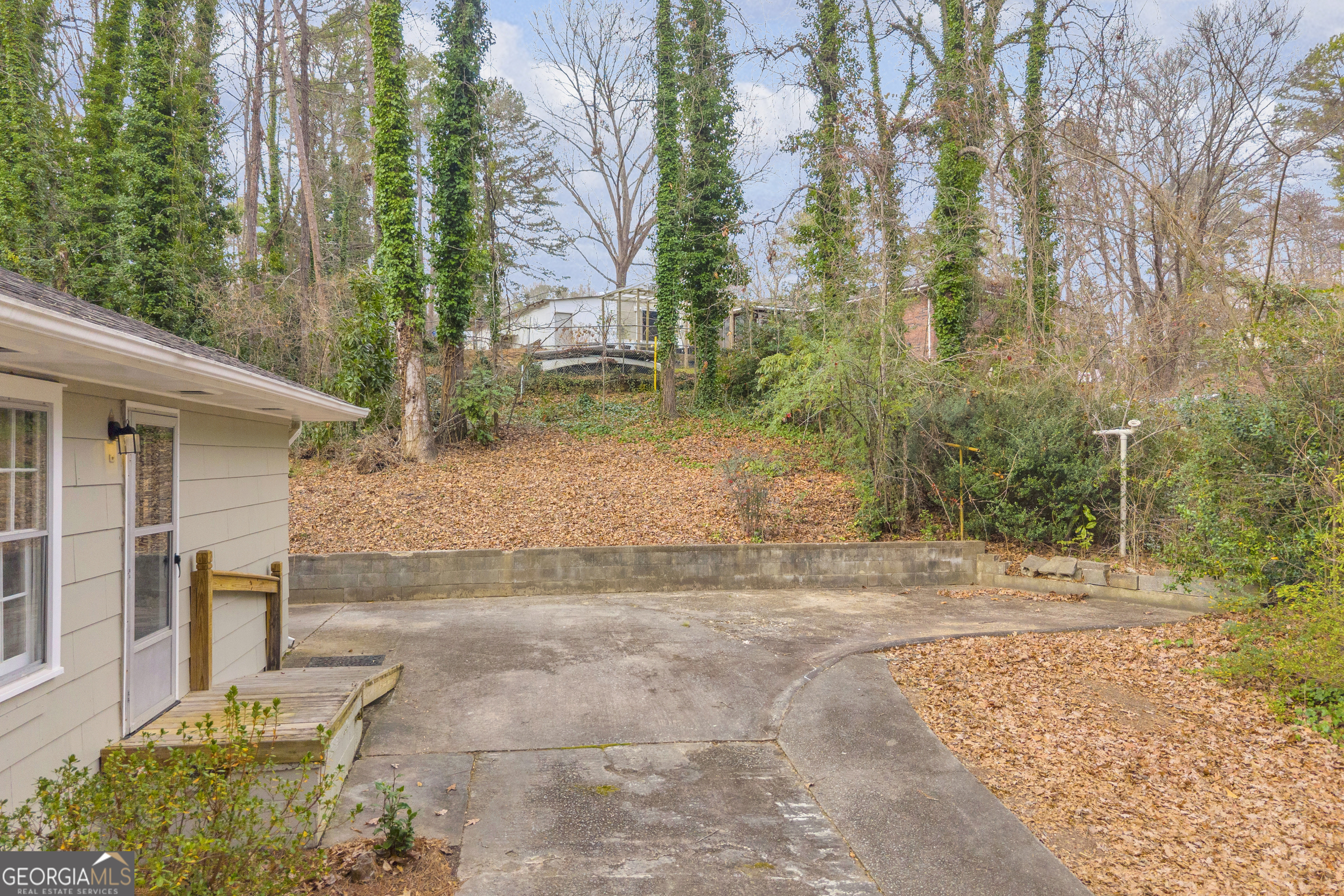 998 Rosedale Street Toccoa, GA 30577 - Photo 15 of 43 a backyard of a house with large trees and outdoor seating