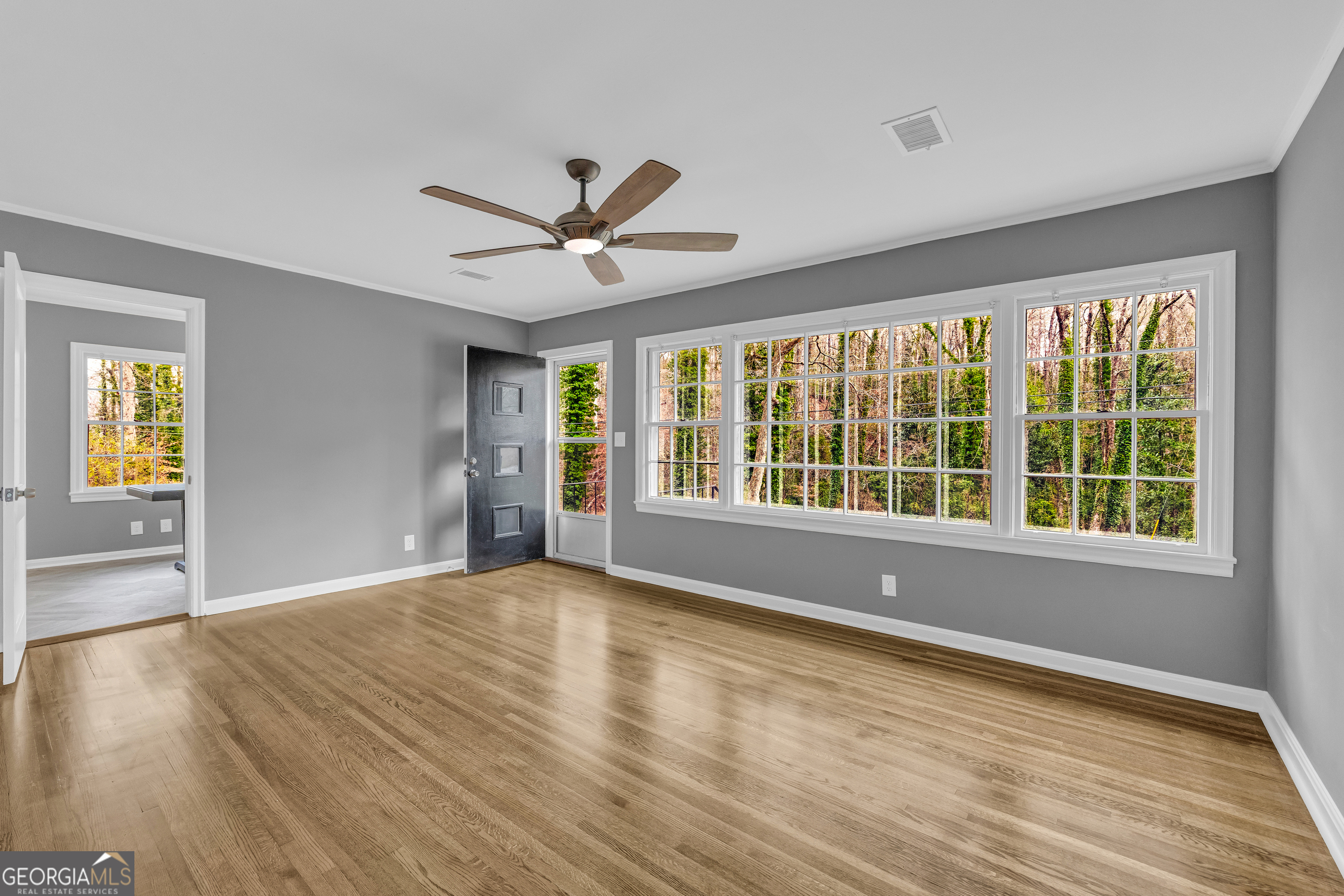 998 Rosedale Street Toccoa, GA 30577 - Photo 20 of 43 a view of an empty room with a window and wooden floor