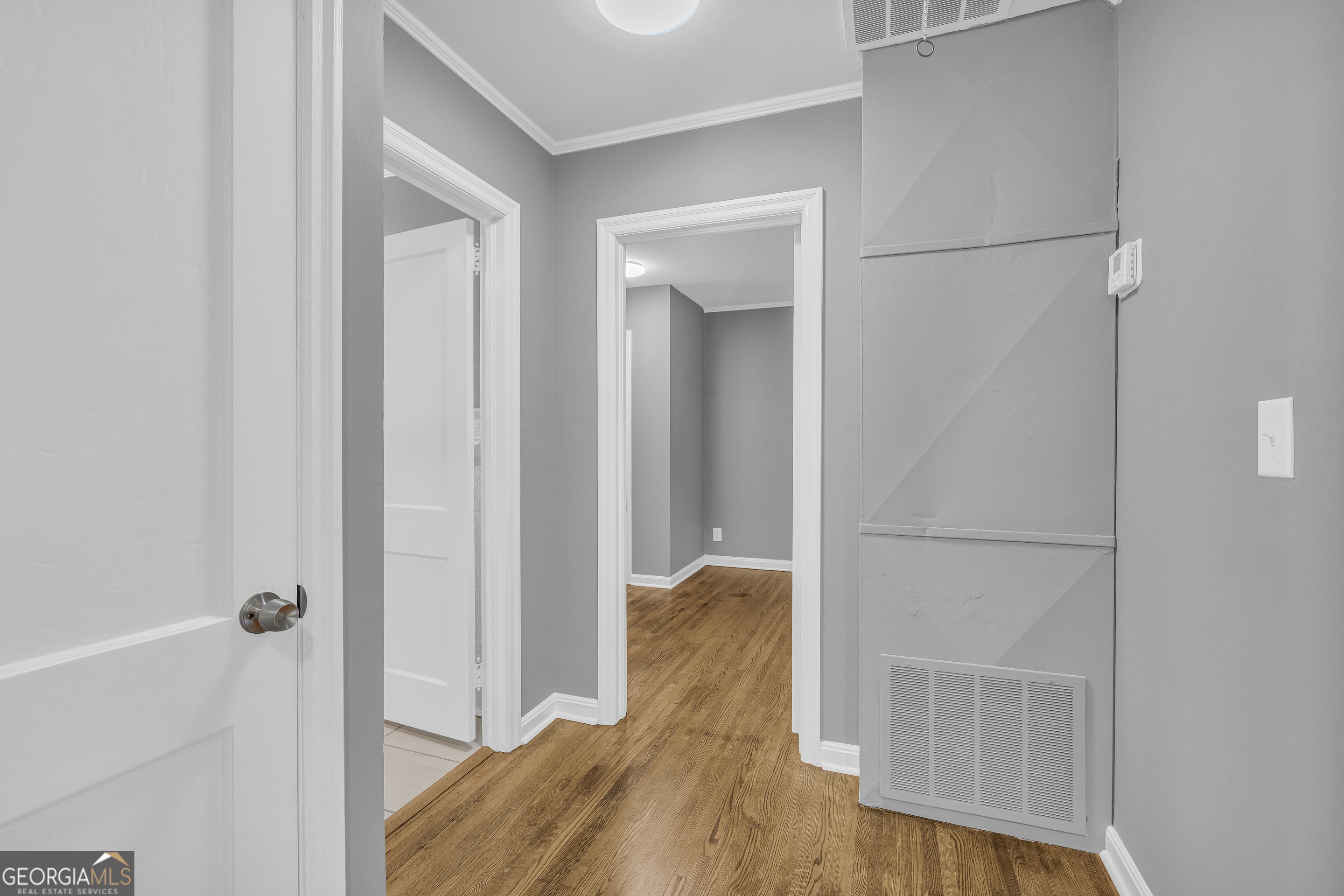 998 Rosedale Street Toccoa, GA 30577 - Photo 27 of 43 a view of walk in closet with bedroom and wooden floor