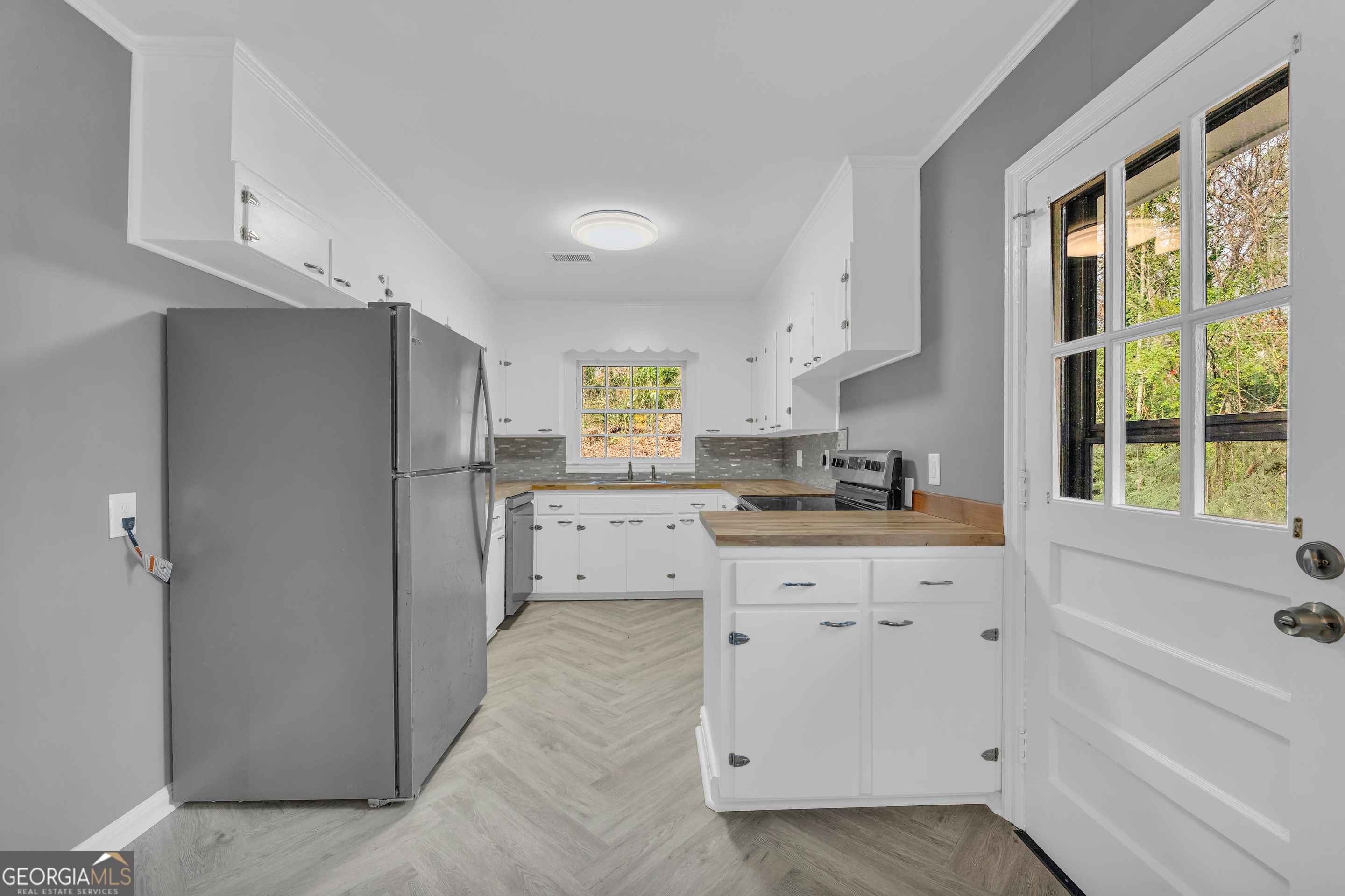 998 Rosedale Street Toccoa, GA 30577 - Photo 37 of 43 a kitchen with white cabinets and window
