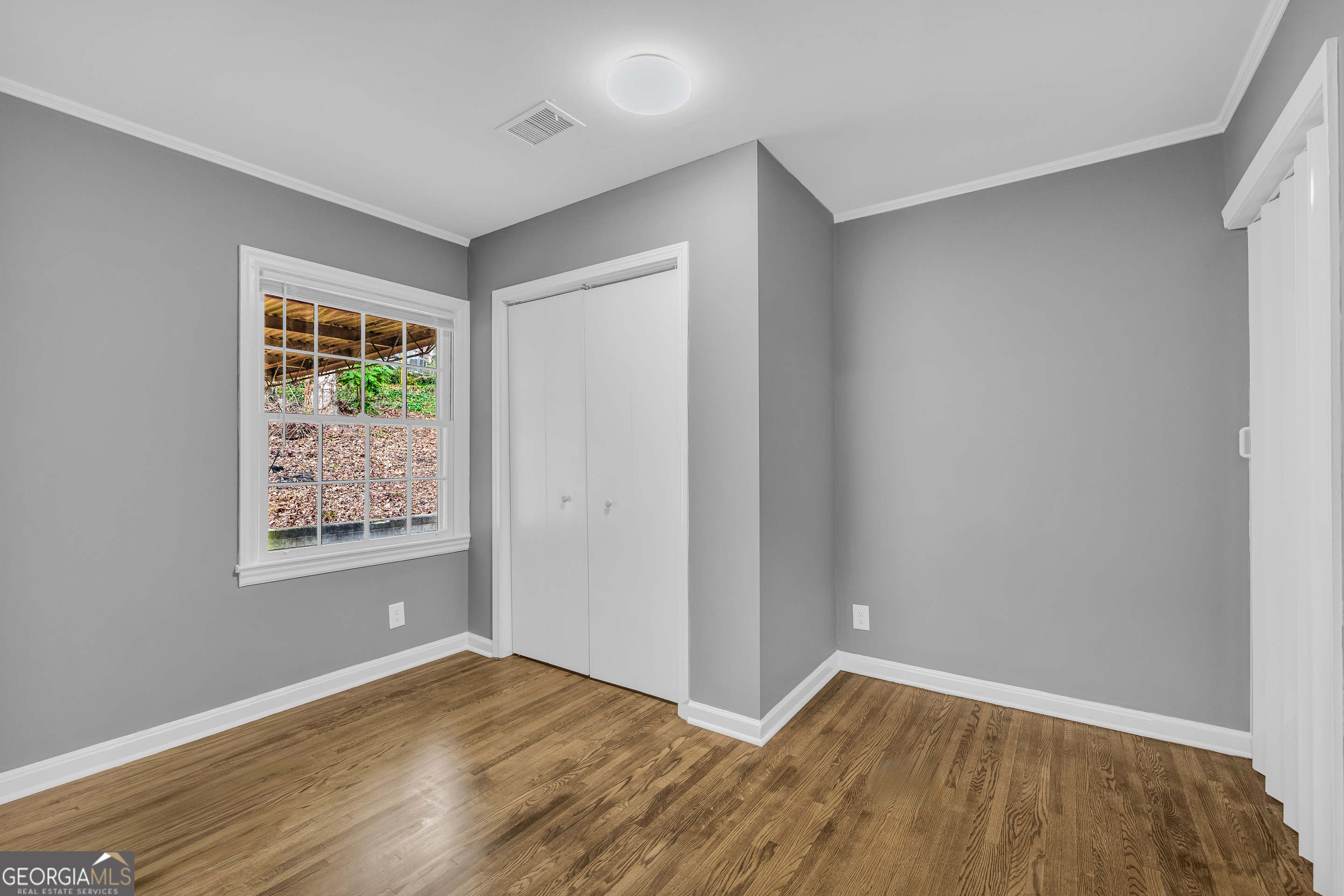 998 Rosedale Street Toccoa, GA 30577 - Photo 6 of 43 a view of an empty room with wooden floor and a window