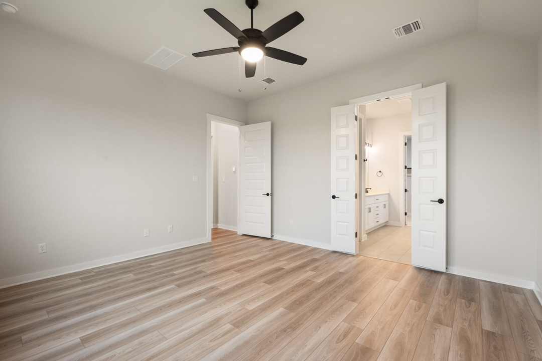 16201 Smithers Road Manor, TX 78653 - Photo 25 of 40 an empty room with wooden floor and a ceiling fan