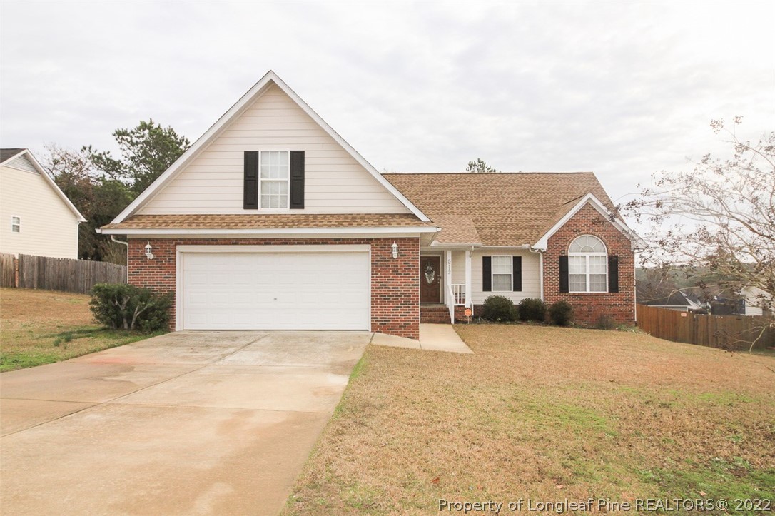 5713 Spreading Branch Road Hope Mills, NC 28348 - Photo 1 of 33 a front view of a house with a yard and garage
