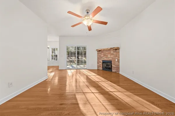 wooden floor in an empty room with a fireplace