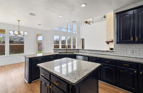 a kitchen with center island table and chairs
