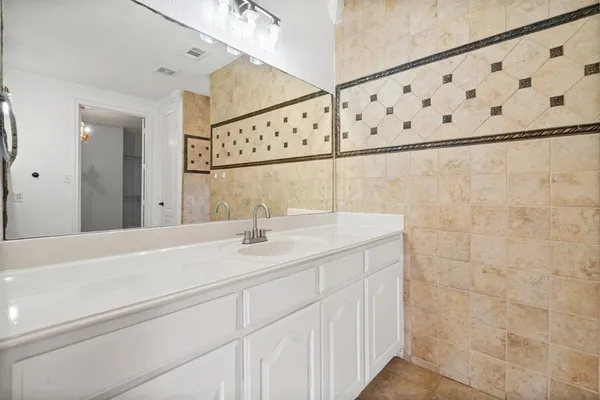 a bathroom with a sink and mirror