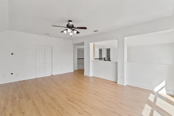 a view of a kitchen with wooden cabinet and a ceiling fan