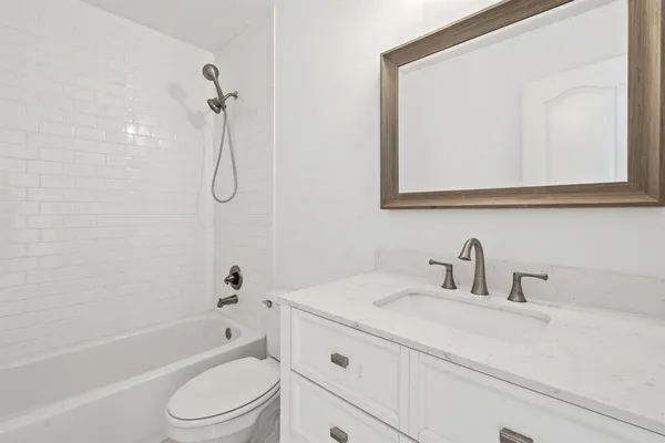 a bathroom with a sink a toilet and a bathtub