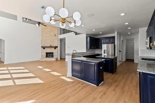 a kitchen with granite countertop a stove and a sink