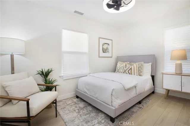 a bedroom with a bed and a painting on the wall