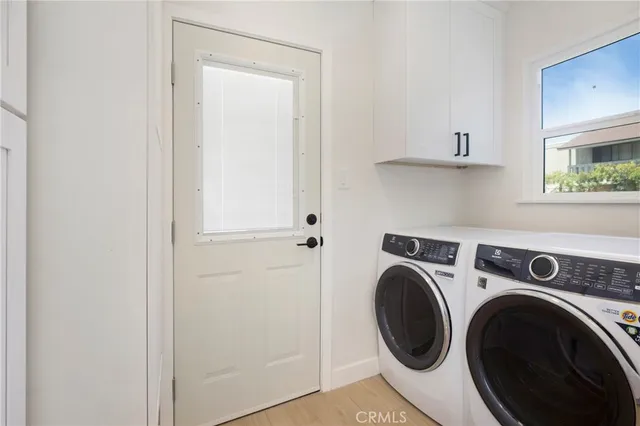 a kitchen with cabinets stainless steel appliances and wooden floor