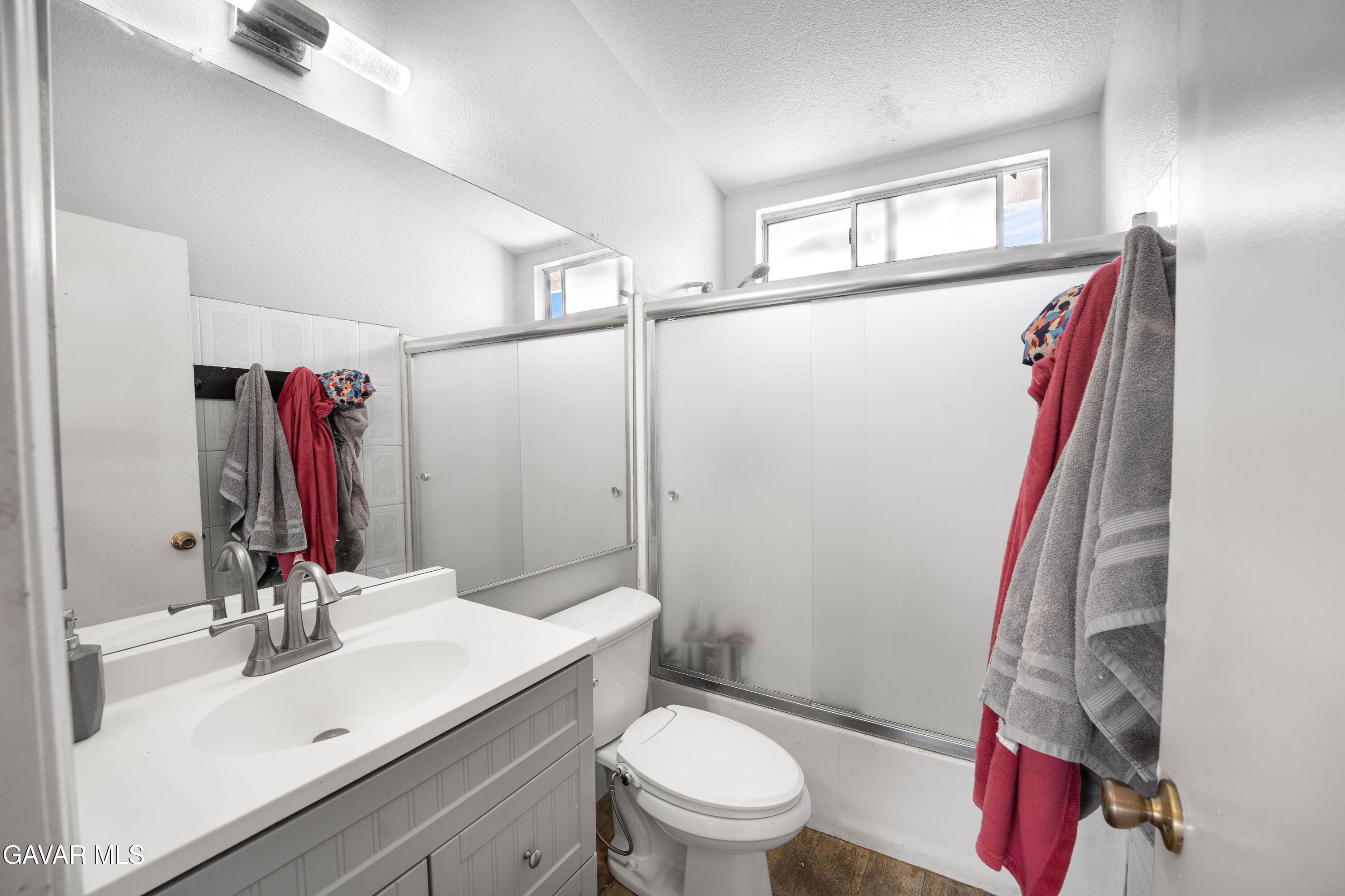 5009 East Ave R 11 Palmdale, CA 93552 - Photo 18 of 23 a bathroom with a sink vanity mirror and toilet