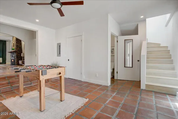 a living room with furniture and stairs
