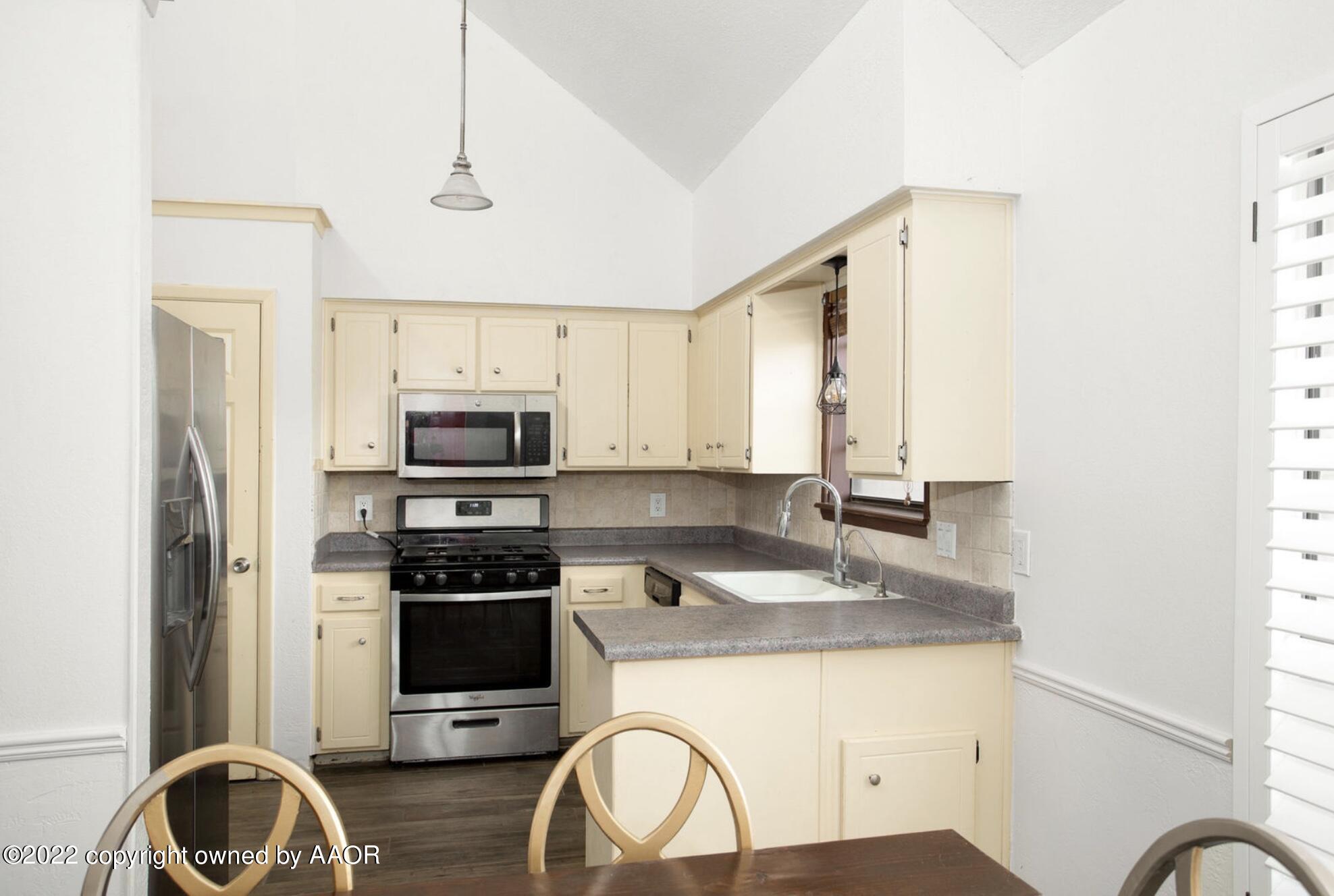 6700 Foothill Drive Amarillo, TX 79124 - Photo 11 of 17 a kitchen with a sink a stove and refrigerator