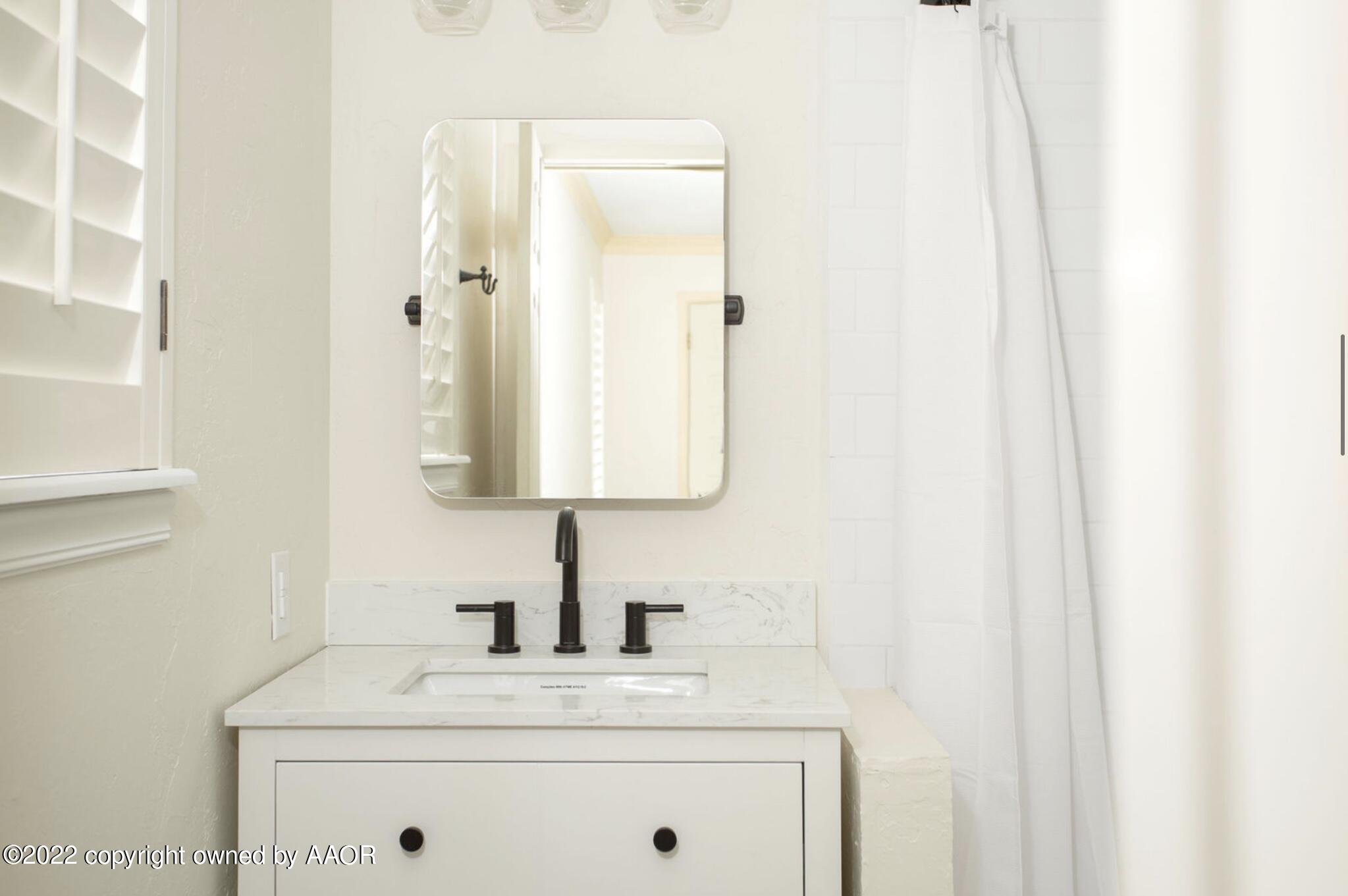 6700 Foothill Drive Amarillo, TX 79124 - Photo 8 of 17 a bathroom with a sink and a mirror
