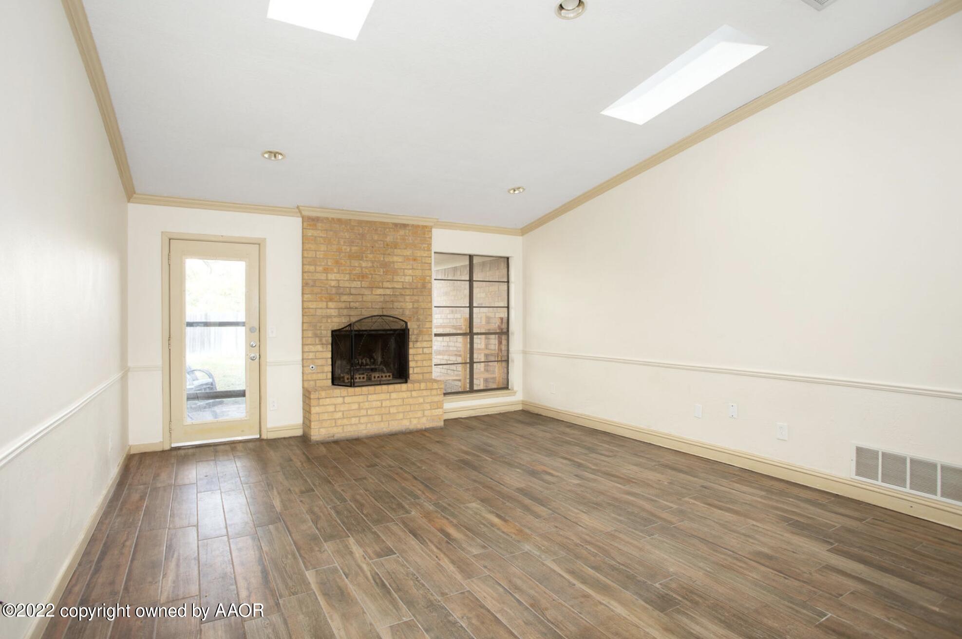 6700 Foothill Drive Amarillo, TX 79124 - Photo 10 of 17 wooden floor in an empty room with a fireplace