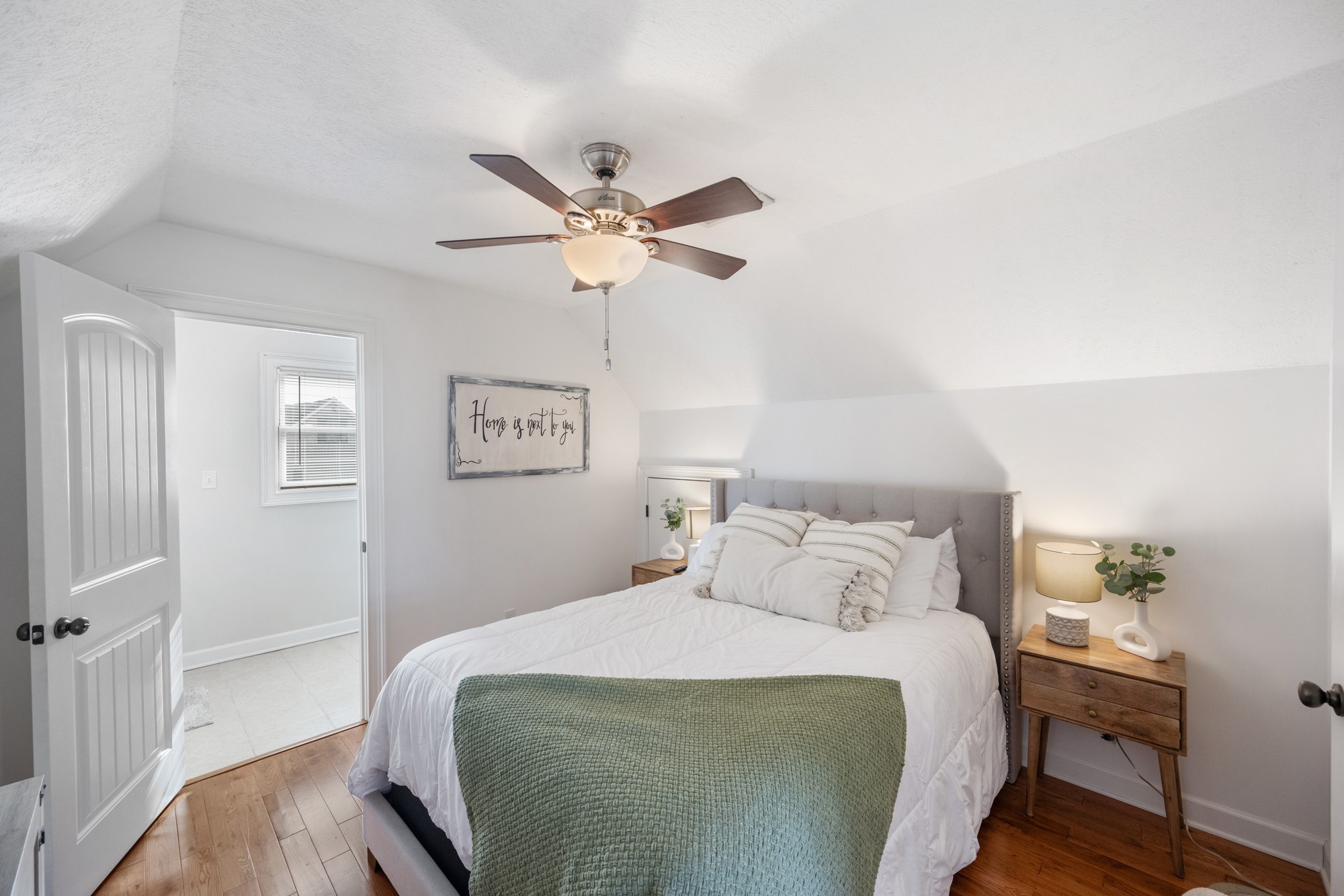 222 Fairway Villa Lane Decaturville, TN 38329 - Photo 17 of 36 a bedroom with a bed and a chandelier