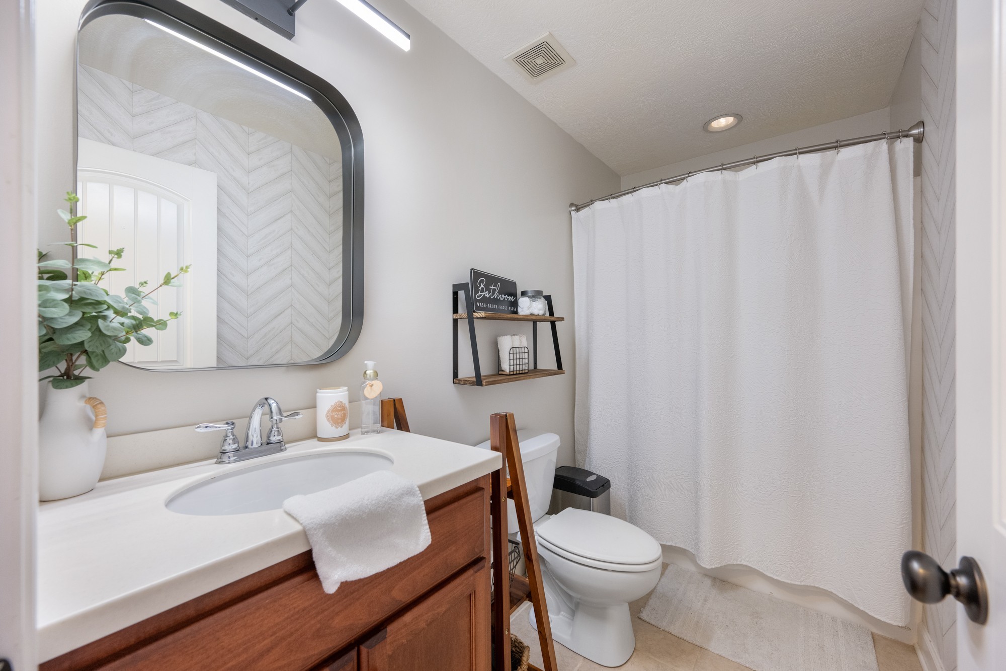 222 Fairway Villa Lane Decaturville, TN 38329 - Photo 20 of 36 a bathroom with a sink vanity mirror and toilet
