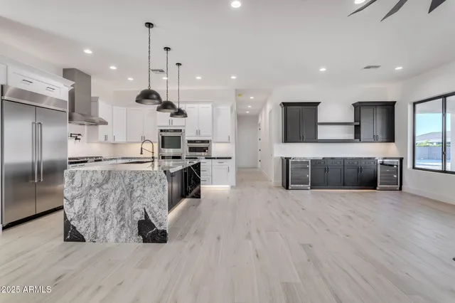 a kitchen with granite countertop cabinets stainless steel appliances and a counter space