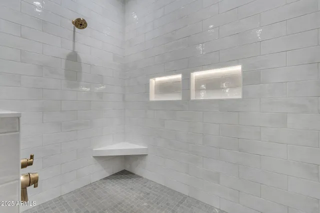 a spacious bathroom with a granite countertop sink and a mirror