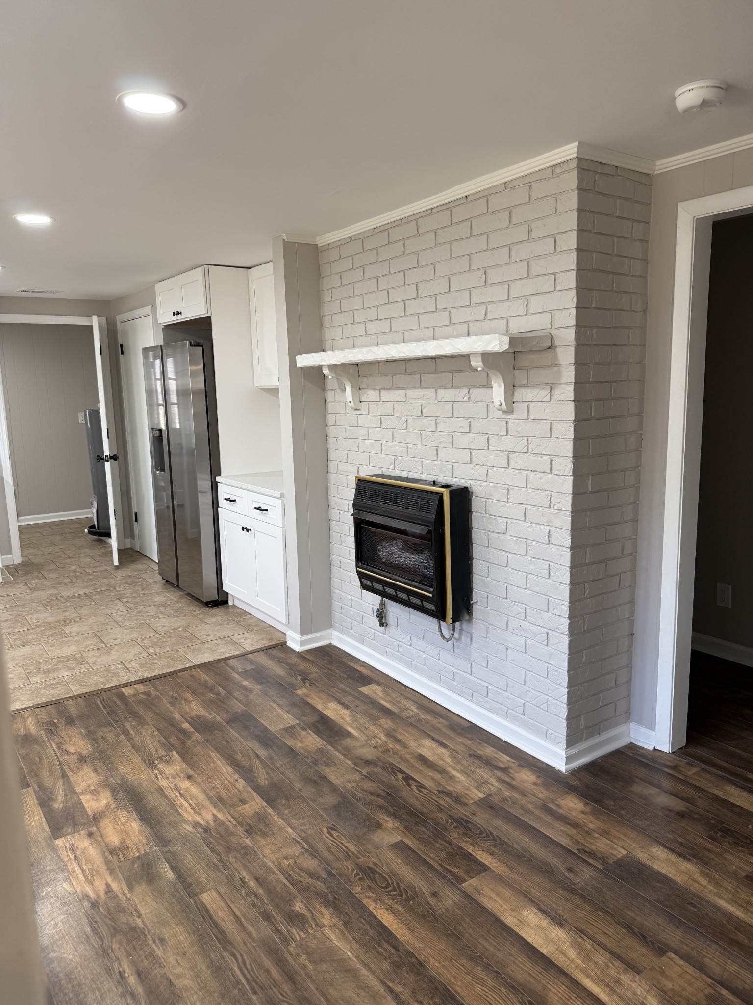 133 Mockerson Road Leoma, TN 38468 - Photo 10 of 20 an empty room with wooden floor fireplace and windows