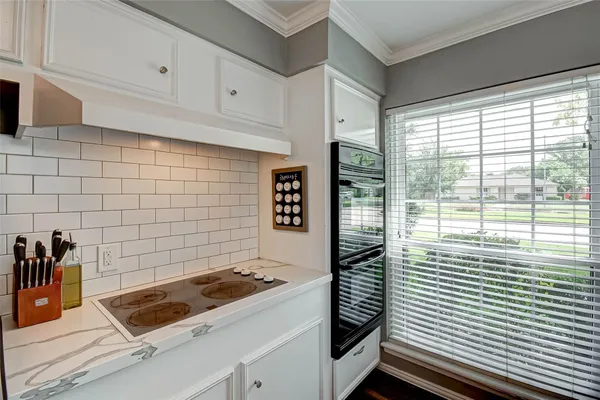 a kitchen with a sink stove and cabinets