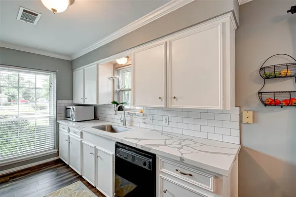 a view of a kitchen with a sink and refrigerator