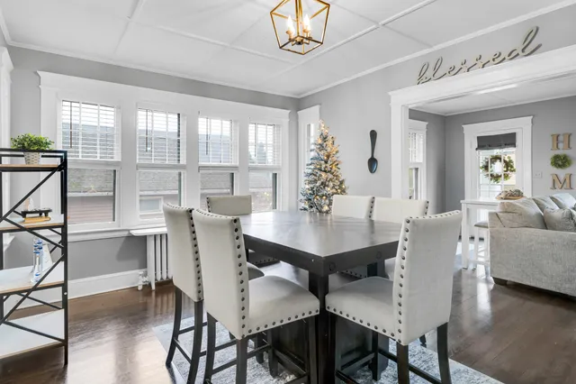a view of a patio with table and chairs with wooden floor and fence