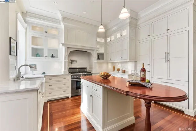 a kitchen with kitchen island a sink cabinets and wooden floor