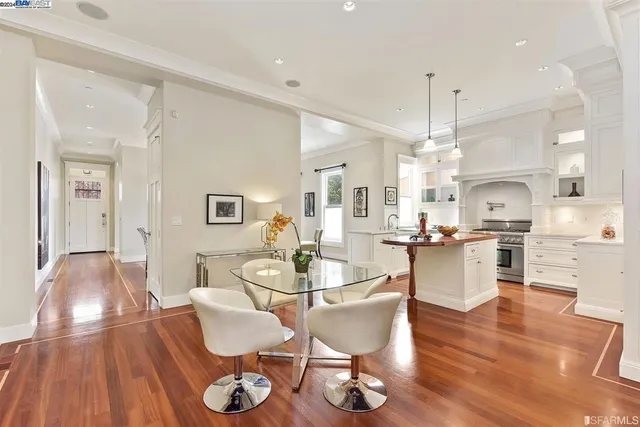a living room with kitchen island furniture and a chandelier