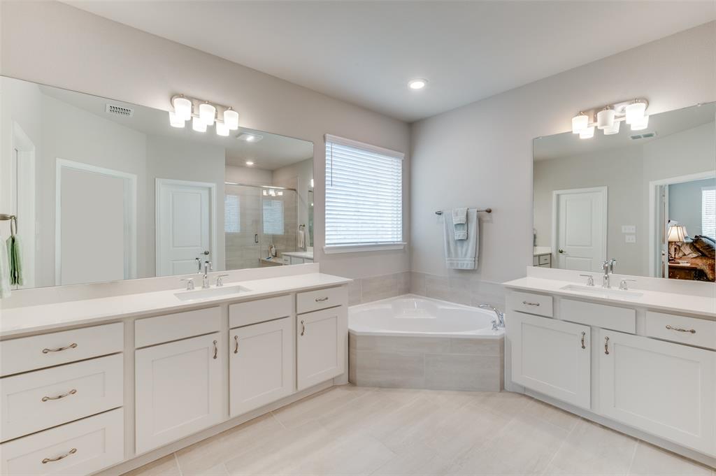 309 Savannah Lane Oak Point, TX 75068 - Photo 14 of 30 a spacious bathroom with a double vanity sink mirror and bathtub