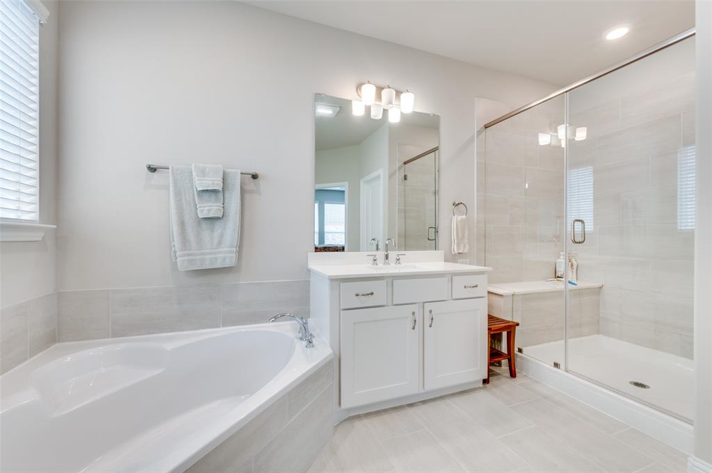309 Savannah Lane Oak Point, TX 75068 - Photo 15 of 30 a bathroom with a tub a sink shower and mirror