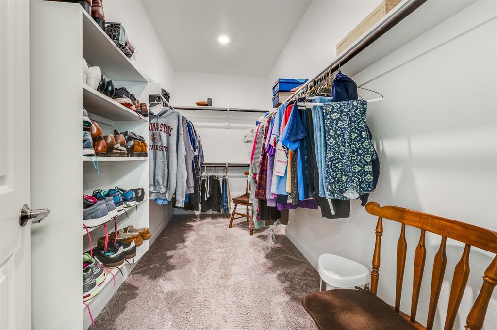 309 Savannah Lane Oak Point, TX 75068 - Photo 16 of 30 a view of walk in closet with clothes and shoes