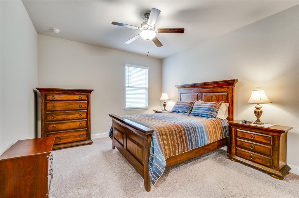309 Savannah Lane Oak Point, TX 75068 - Photo 17 of 30 a bedroom with a bed and a ceiling fan