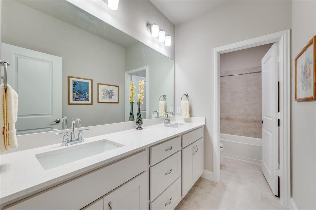 309 Savannah Lane Oak Point, TX 75068 - Photo 18 of 30 a bathroom with a sink double vanity and tub