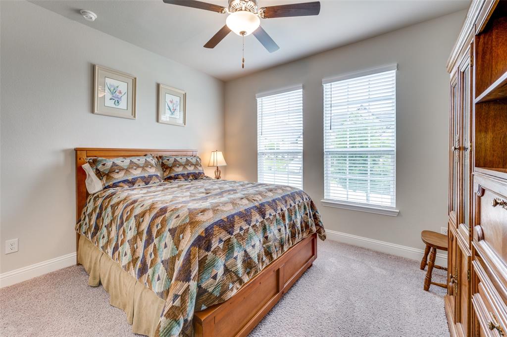 309 Savannah Lane Oak Point, TX 75068 - Photo 19 of 30 a bed sitting in a bedroom next to a window