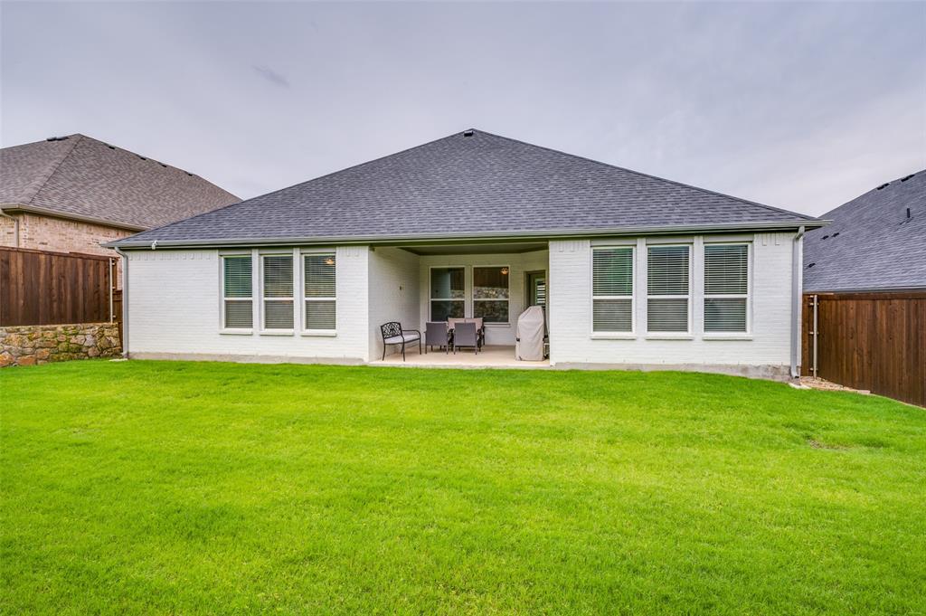 309 Savannah Lane Oak Point, TX 75068 - Photo 26 of 30 a front view of a house with a garden