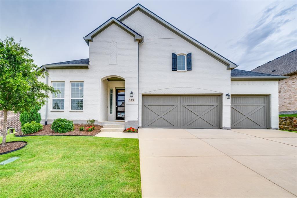 309 Savannah Lane Oak Point, TX 75068 - Photo 27 of 30 a front view of a house with a yard and garage