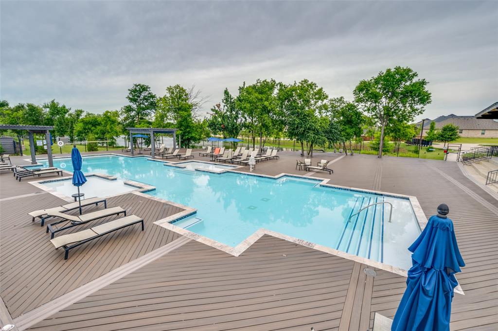 309 Savannah Lane Oak Point, TX 75068 - Photo 29 of 30 a view of swimming pool with seating area and trees in the background