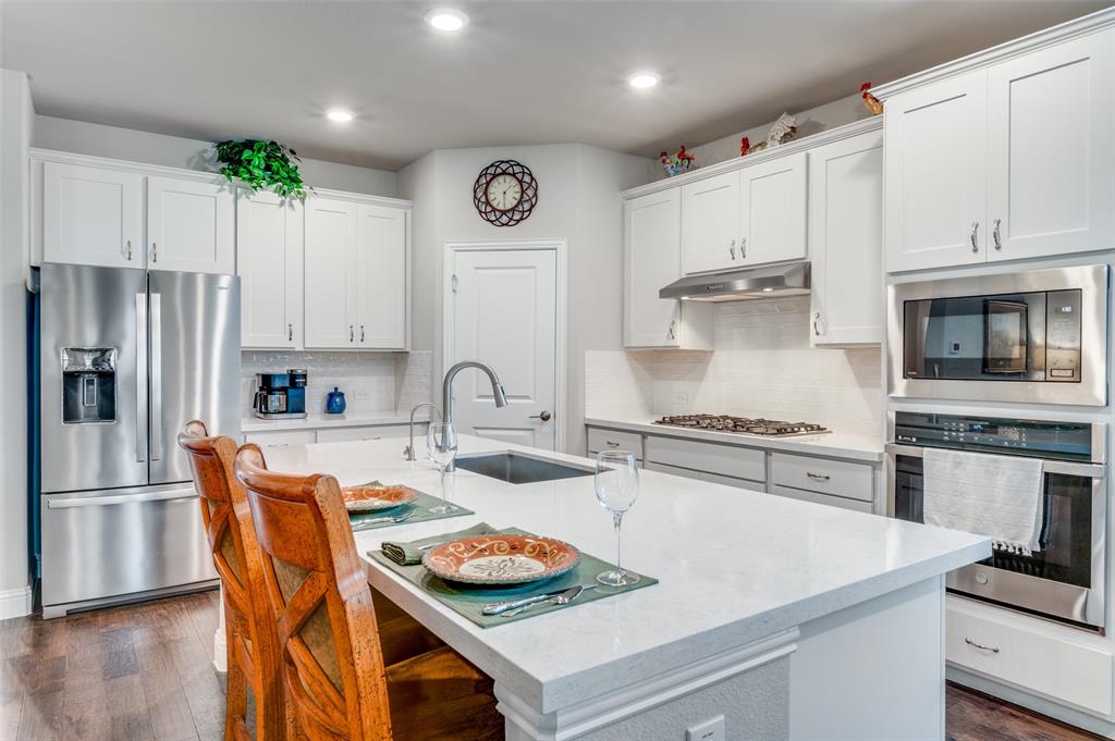309 Savannah Lane Oak Point, TX 75068 - Photo 3 of 30 a kitchen with stainless steel appliances granite countertop a stove a sink and a refrigerator