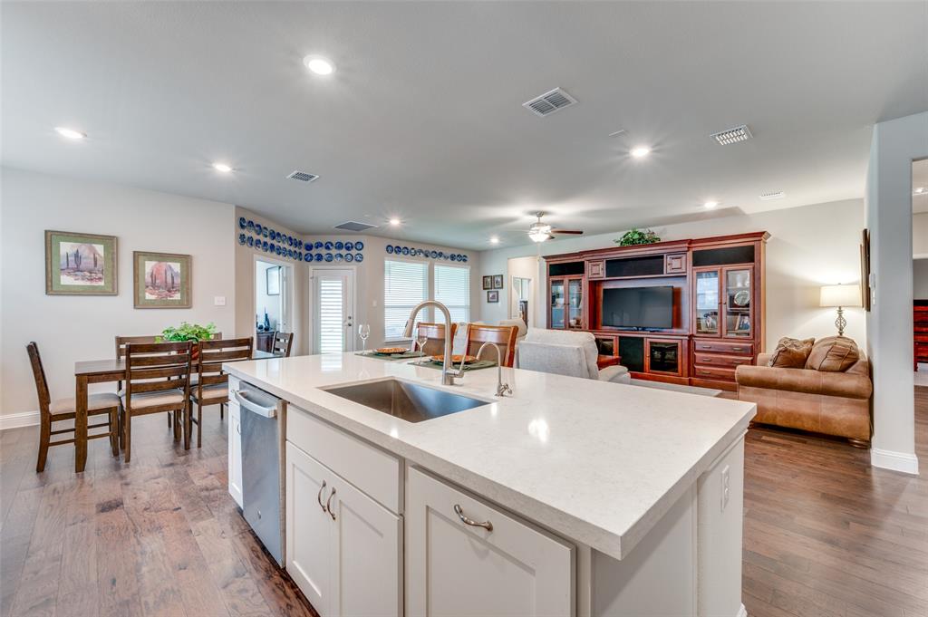 309 Savannah Lane Oak Point, TX 75068 - Photo 6 of 30 a kitchen with stainless steel appliances granite countertop a sink a stove and a refrigerator