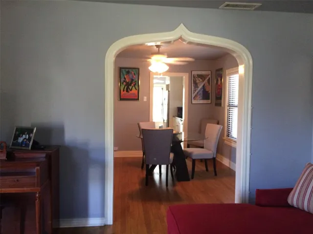 a view of a dining room with furniture and wooden floor
