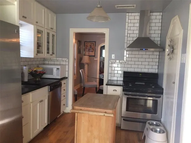 a kitchen with a stove and a microwave